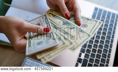 Close-up Of Woman Holding Cash In Hand And Counting Banknotes. Financial Accounting Plan. Earned Mon
