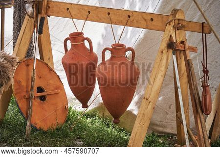 Ancient Roman Camp Items - Jug, Swords And Shild. Reconstruction Of Military Events During The Wars 
