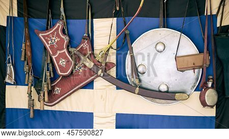 Vintage Bow, Arrows In A Quiver And A Retro Sword In A Scabbard On The Background Of The Swedish Fla