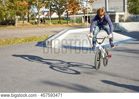Eschborn, Germany - October 12, 2009: Joung Red Haired Boy Is Jumping With His Bmx Bike At The Skate
