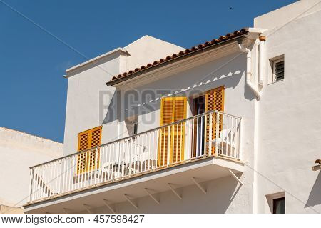 Cala Ratjada, Mallorca, Spain; June 25th, 2022: White House With Yellow Shutters In The Cala Ratjada