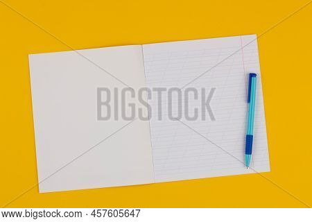 School Notebook On A Yellow Background With Copy Space For Text, Colorful Markers, English Alphabet.