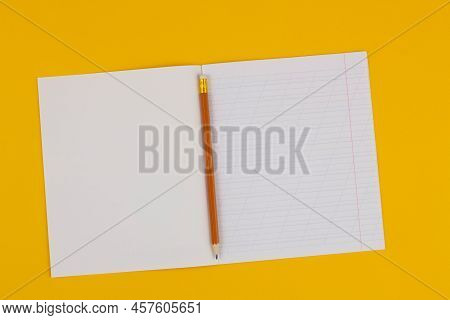 School Notebook On A Yellow Background With Copy Space For Text, Colorful Markers, English Alphabet.