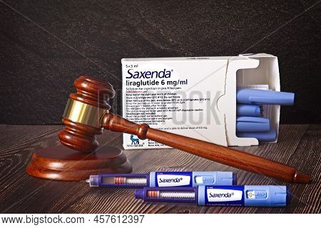 Judges Hammer, Saxenda Injection Pens On A Wooden Background. Injections For Weight Loss, Lower Bloo