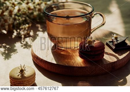 Aesthetic Brunch Of Tea Time, Herbal Tea And Macarons Dessert Outside In The Terrace Under Trendy Ha