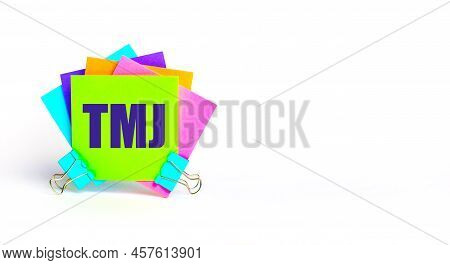 There Are Bright Multi-colored Stickers With The Text Tmj. Copy Space
