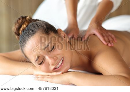 Woman Complaining And Physiotherapist Doing Massage To Remove A Contracture