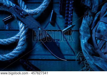 Military Composition With A Knife And Cartridge Cases. Military Knife, Shell Casings And Camouflaged