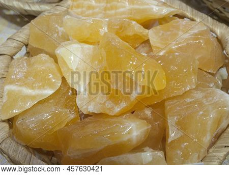 Yellow Calcite Fragments, Believed To Have Beneficial Health Properties. Displayed On Basket At Stre