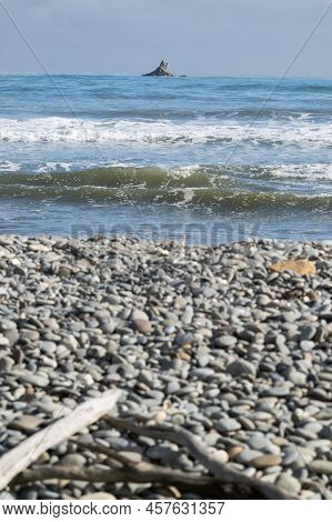 Off-shore Rock Beyond Stony Rapahoe Beach And View To Horizon With Headland And Surf Waves, Reefton,