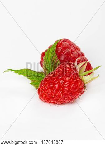 Ripe Raspberries With Leaves Isolated On White Background