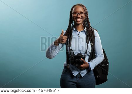 Cheerful Professional Photography Entusiast With Dslr Device Saying Is Ready For Photo Shooting By G