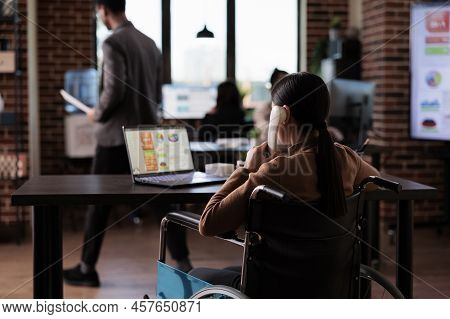 Company Worker With Physical Impairment Talking On Landline Phone, Having Remote Conversation On Off
