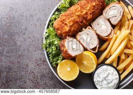 Serbian Breaded Rolled Cutlet Karageorge Schnitzel With French Fries And Tartar Sauce Close-up In A 