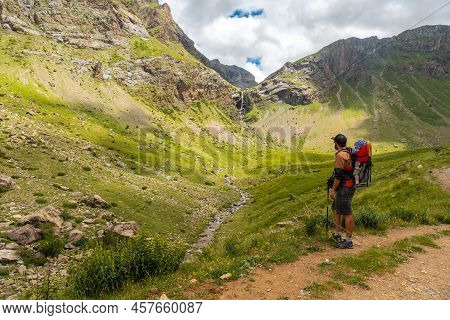 A Young Man Next To The Salto De Tendenera Waterfall In The Ripera Valley, Panticosa, Pyrenees