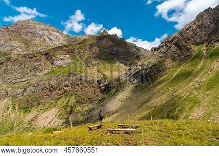 A Young Woman Next To The Salto De Tendenera Waterfall In The Ripera Valley, Panticosa, Pyrenees
