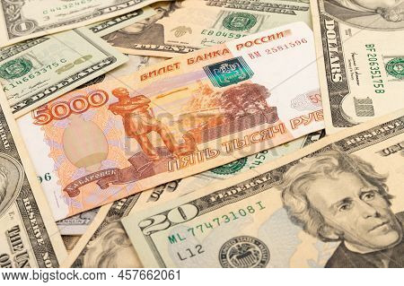 Russian 5000 Rubles And 100 Dollars Close Up, Concept Of Finance Is Laid Out As A Background. Ruble 