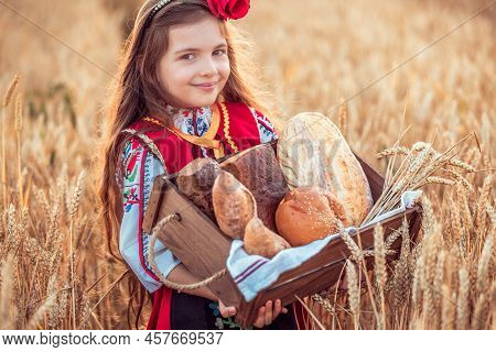 Beautiful Girl Woman In Traditional Bulgarian Folklore Dress Holding Wicker Basket With Homemade Bre