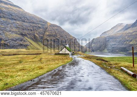 Beautiful Little Church, With A Grassy Roof, Against The Backdrop Of Beautiful Mountains, And Dramat