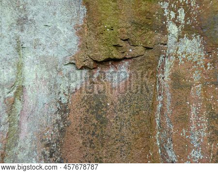 Close Up Of Weathered Sandstone Rock With Mosses, Lichens And Cracks In Rock