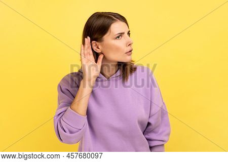 Portrait Of Pretty Woman Holding Hand Near Ear, Listening Attentively With Interest Private Conversa