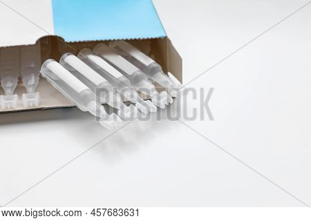 Package With Single Dose Ampoules Of Sterile Isotonic Sea Water Solution On White Background. Space 