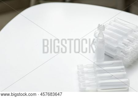 Single Dose Ampoules Of Sterile Isotonic Sea Water Solution On White Table. Space For Text
