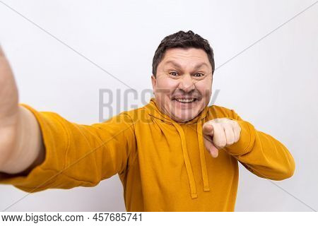 Portrait Of Delighted Man Blogger Pointing At You, Looking At Camera With Toothy Smile, Pov, Point O