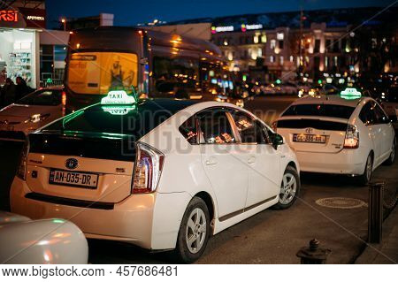 Tbilisi, Georgia - March 28, 2022: View On White Toyotas Prius Used As A Taxi. Conception Of City Tr