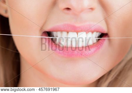 Dental Flush - Woman Flossing Teeth. Dental Floss. Taking Care Of Teeth. Healthy Teeth Concept. Teet