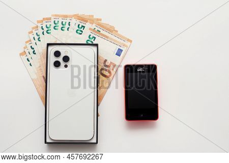 Stariy Oskol, Russia - July 5, 2021: New Smartphone Iphone Next To The Old Phone
