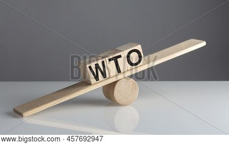 Wto - World Trade Organization, Text On A Wooden Cubes On A Wooden Balance , Business Concept