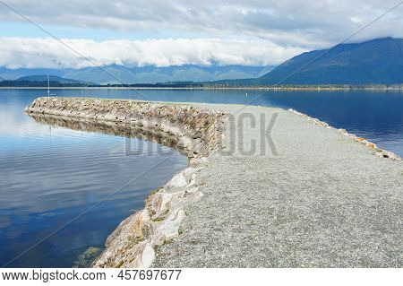 Breakwater Projecting Into Scenic Alpine Lake Brunner In South Island New Zealand