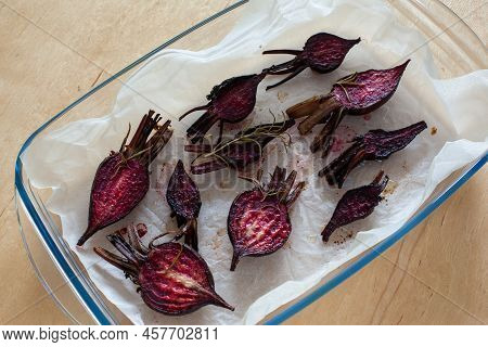 Glazed And Roasted Young Beets On A Piece Of Baking Paper, Baked Baby Beets On The Wooden Background