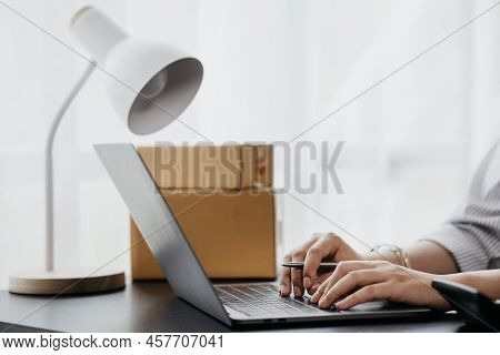 Close-up Of Person Typing On Laptop Keyboard, Online Store Owner Typing In Response To Customers Who