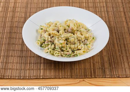Prepared Short Curved Ruffled Pasta, So-called Creste Di Galli Or Rooster Comb, Mixed With Stewed Mi