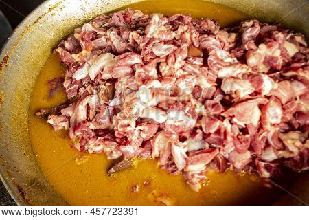 Traditional Cooking Raw Meat With Yellow Curry Or Tongseng In Pan. Tongseng Is Traditional Curry Foo