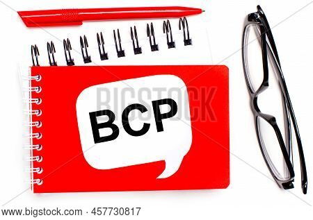 On A White Background, White And Red Notepads, Black Glasses, A Red Pen And A White Card With The Te