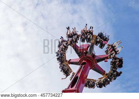Russia, Sochi 14.05.2022. A Huge Round Amusement Ride Turned The Merry People Upside Down, Raising T