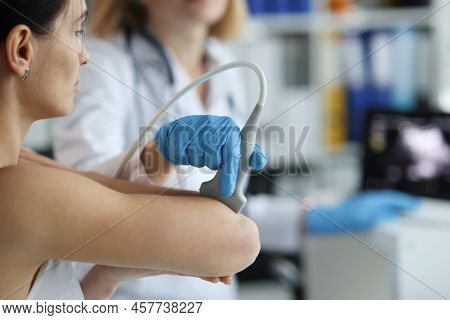 Patient With Orthopedic Doctor Makes Ultrasound Of Elbow Joint In Clinic. Medical Research And Arthr