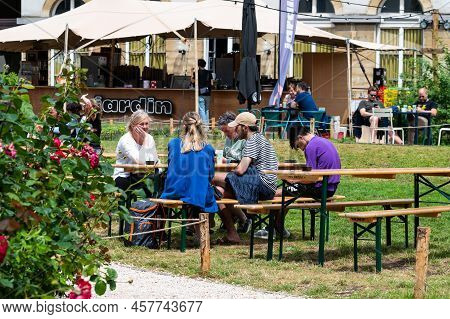 Brussels Old Town, Brussels Capital Region, Belgium - 06 26 2022 - Friends Having A Drink At The Jar