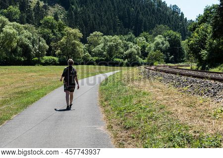 Woman Walking Along The Railway Tracks Towards Trier, Kordel, Rhineland Palatinate - Germany