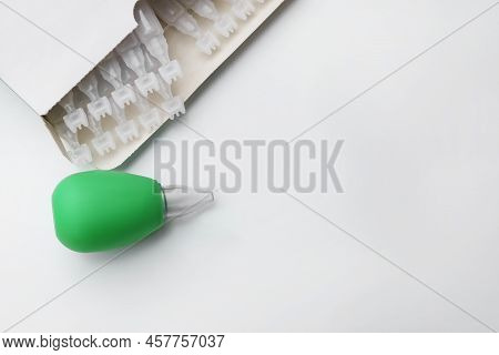 Package With Single Dose Ampoules Of Sterile Isotonic Sea Water Solution And Nasal Aspirator On Whit