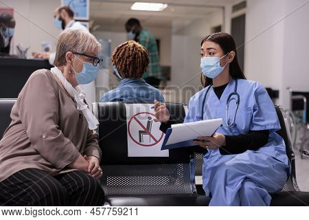 Diverse People With Face Mask In Waiting Room Lobby, Doong Checkup Consultation During Coronavirus E