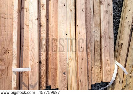 Lumber From Manufacturing Plie On The Ground At Construction Site. Top View Of Wood Plank, Preparati