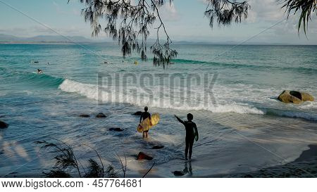 Byron Bay, Australia - Nov 3 2021: Two Longboard Surfers Check Out The Waves At Wategos Beach Of Byr