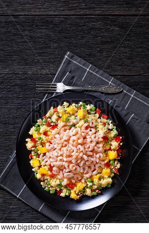 Cooked Small Pink Shrimps Topped Over Millet Pilaw Green Peas, Red Peppers And  Mango Chunks On Blac