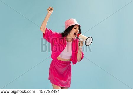 Portrait Of Beautiful Young Girl In Pink Panama Posing Isolated Over Light Blue Studio Background. E