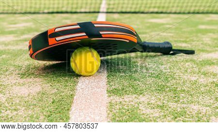 Yellow Ball Down Of Padel Racket Behind Net On A Green Court Grass Turf Outdoors