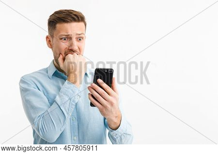A Man With A Smartphone Is In A Panic Due To The Fall Of The Cryptocurrency Market. Inflation Has Br